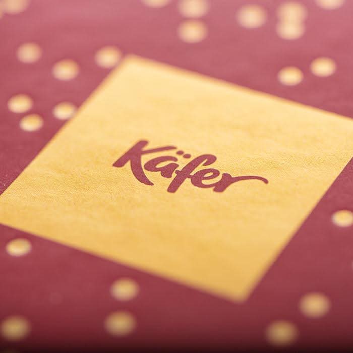 Rote Geschenkbox mit Laurent - Perrier Brut und Pralinen -